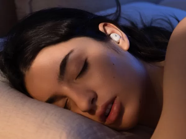 Sleeping person wearing Soundcore Sleep A30 earbuds