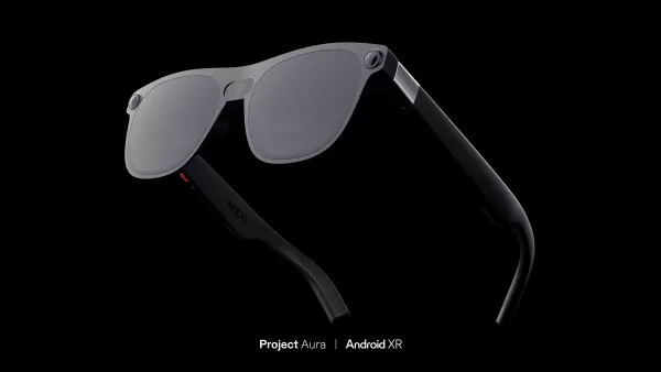 Render of what looks like a pair of regular sunglasses but with a camera in the hinge. The words Project Aura and Android XR at at the bottom.